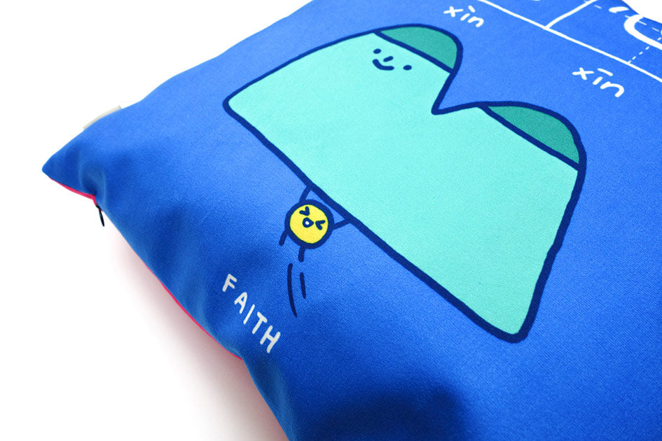 Up-close of 'faith' cushion cover in blue with 'mustard seed can move mountains' illustration.