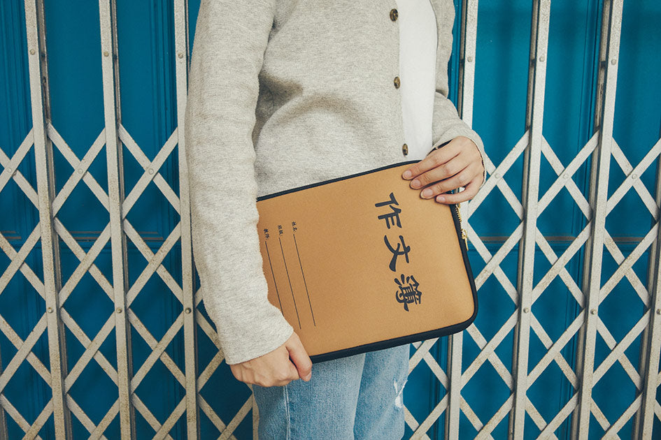 Handheld laptop case with unique Chinese Composition Book design