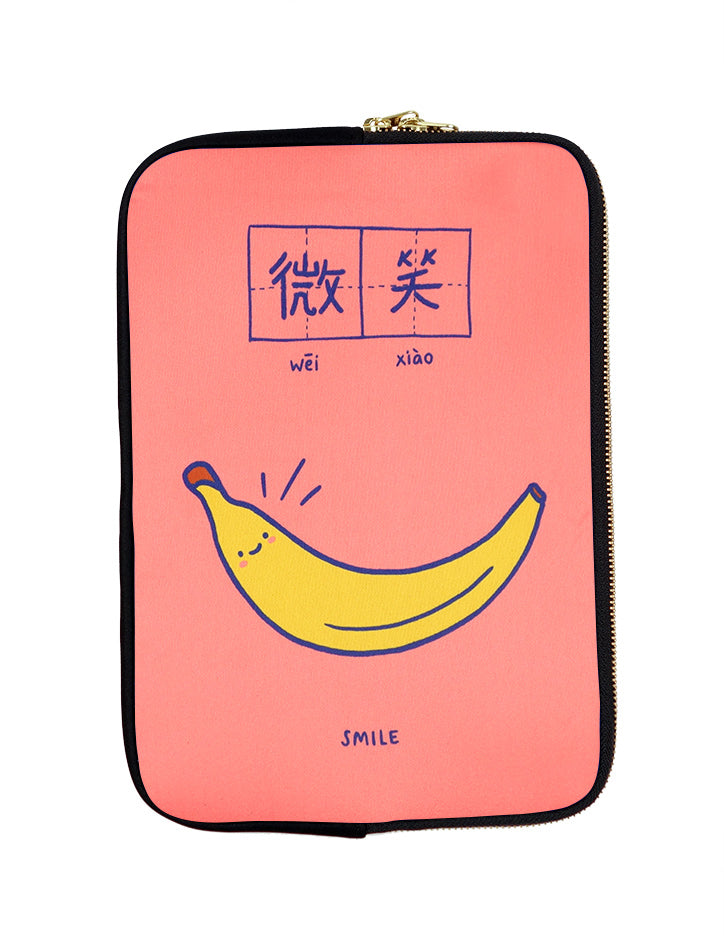 Peach and blue motivational laptop sleeves with a banana saying smile